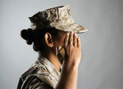 Side view of head, shoulder of a woman in uniform saluting